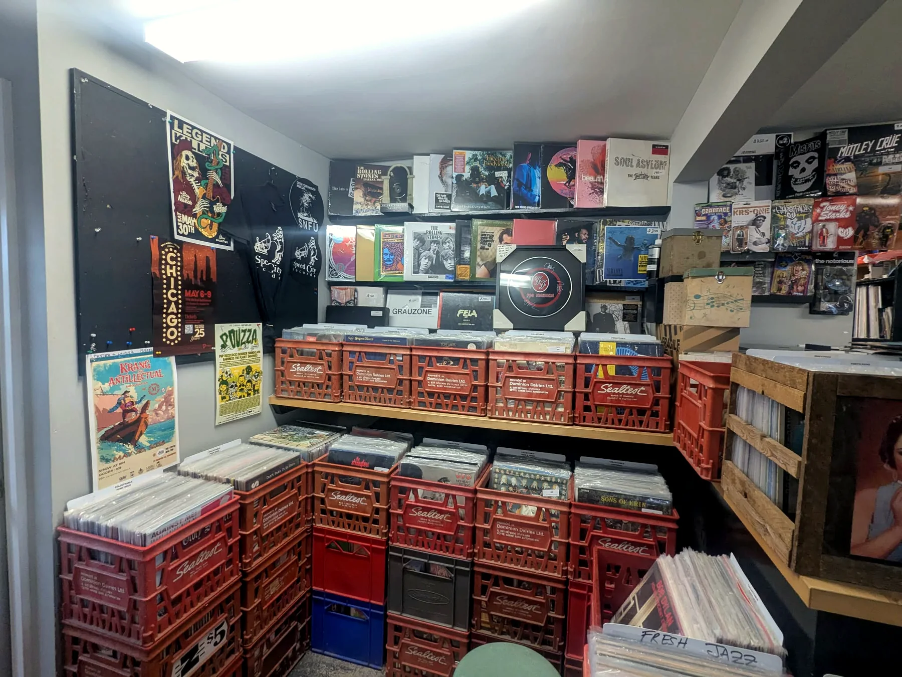Inside Speed City Records with red crates packed with records, wall posters, and stacked CDs