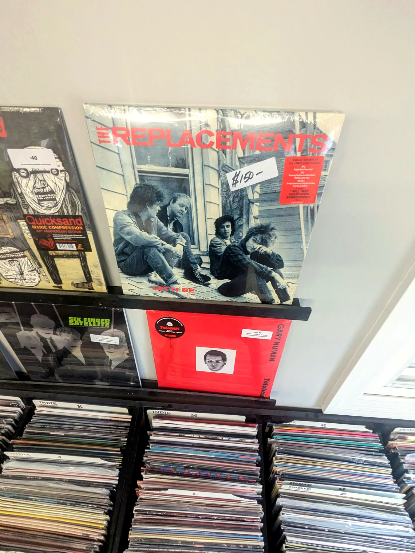 The Replacements and other records displayed above the bins at Speed City Records